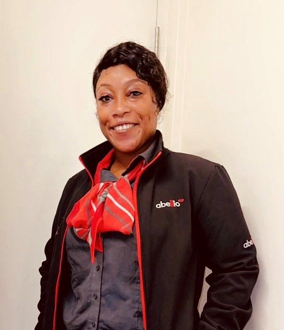 Bus driver Woman smiling and wearing Abellio uniform